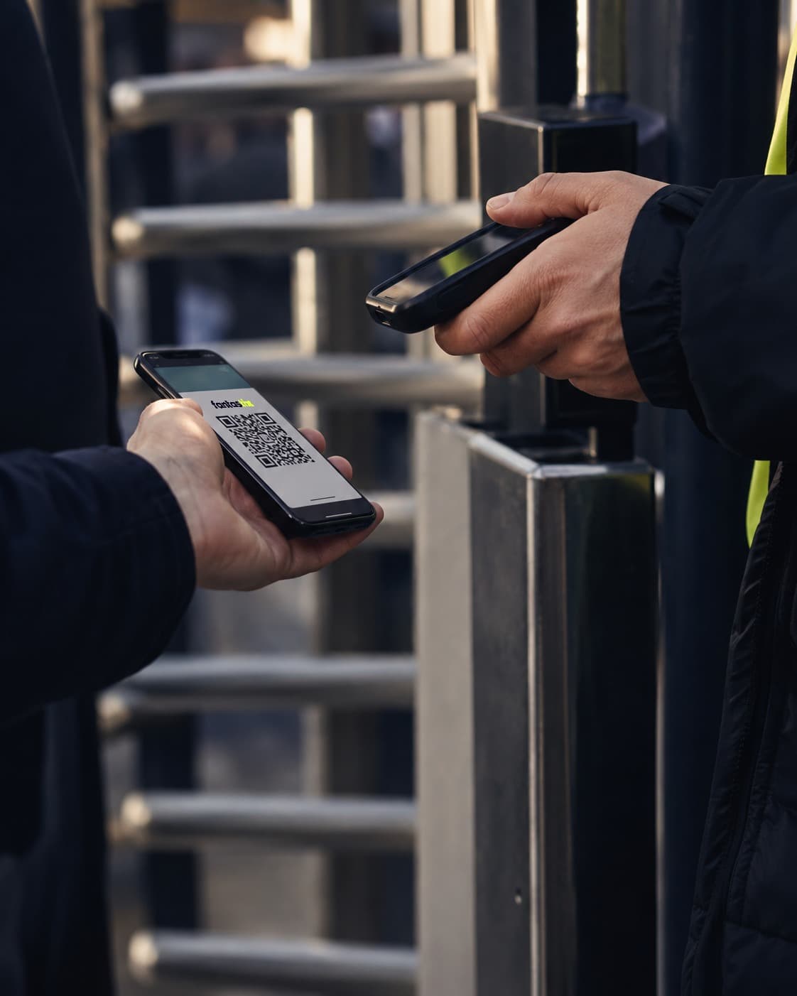 A steward scanning the QR code on a fan's Fantastix ticket at a turnstile